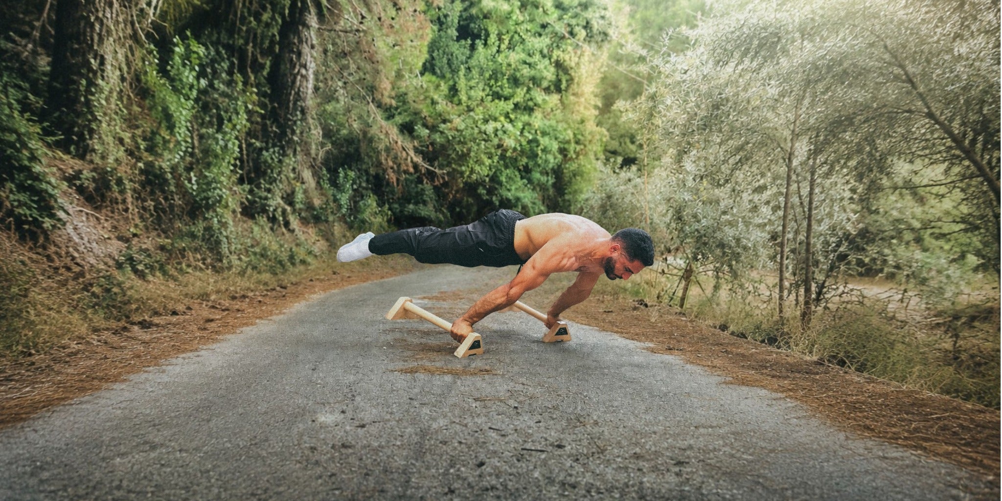 Athlete performing a planche on XENGINEERS X-Parallettes outdoors